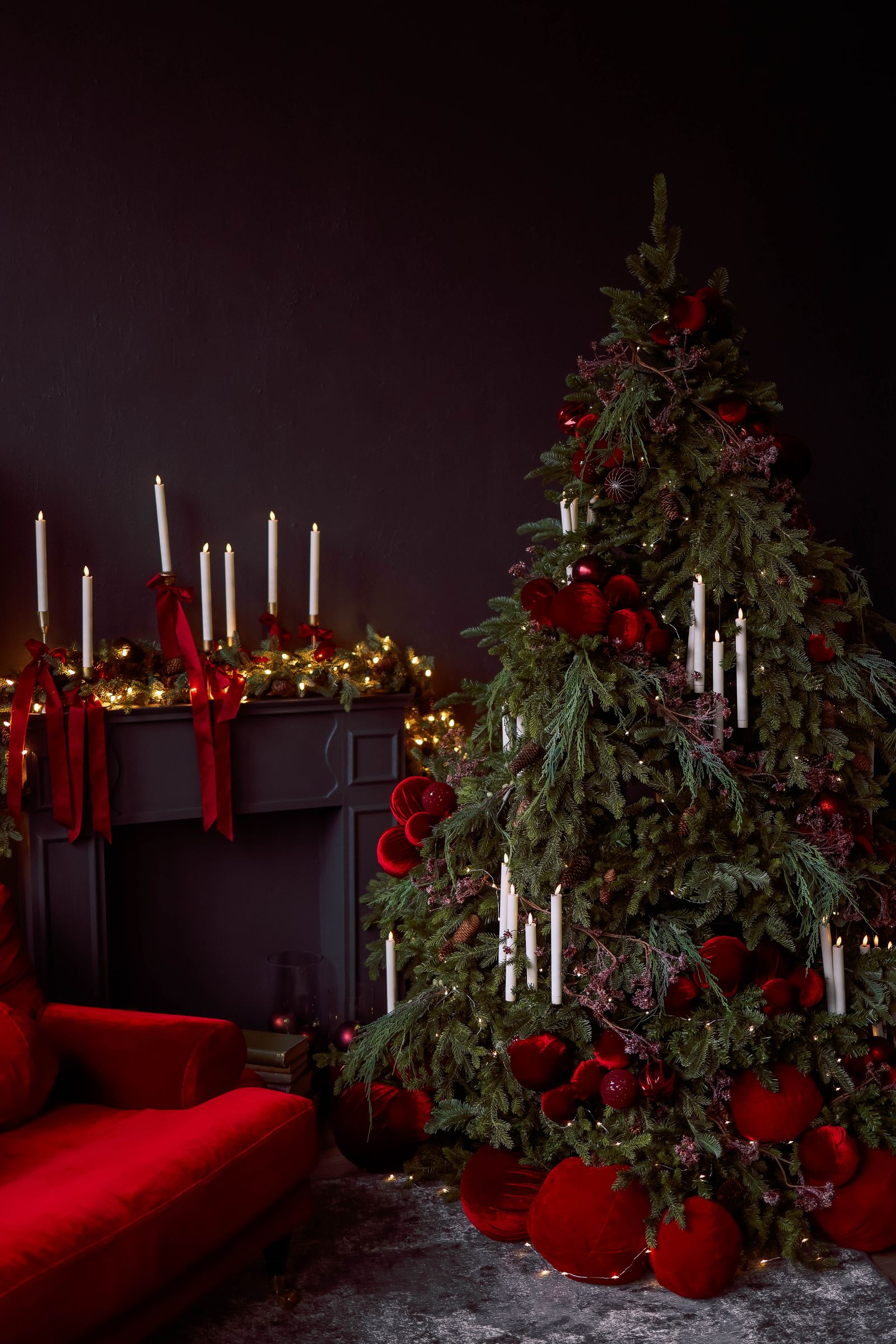 A decorated Christmas tree with lit candles creating a cozy festive atmosphere