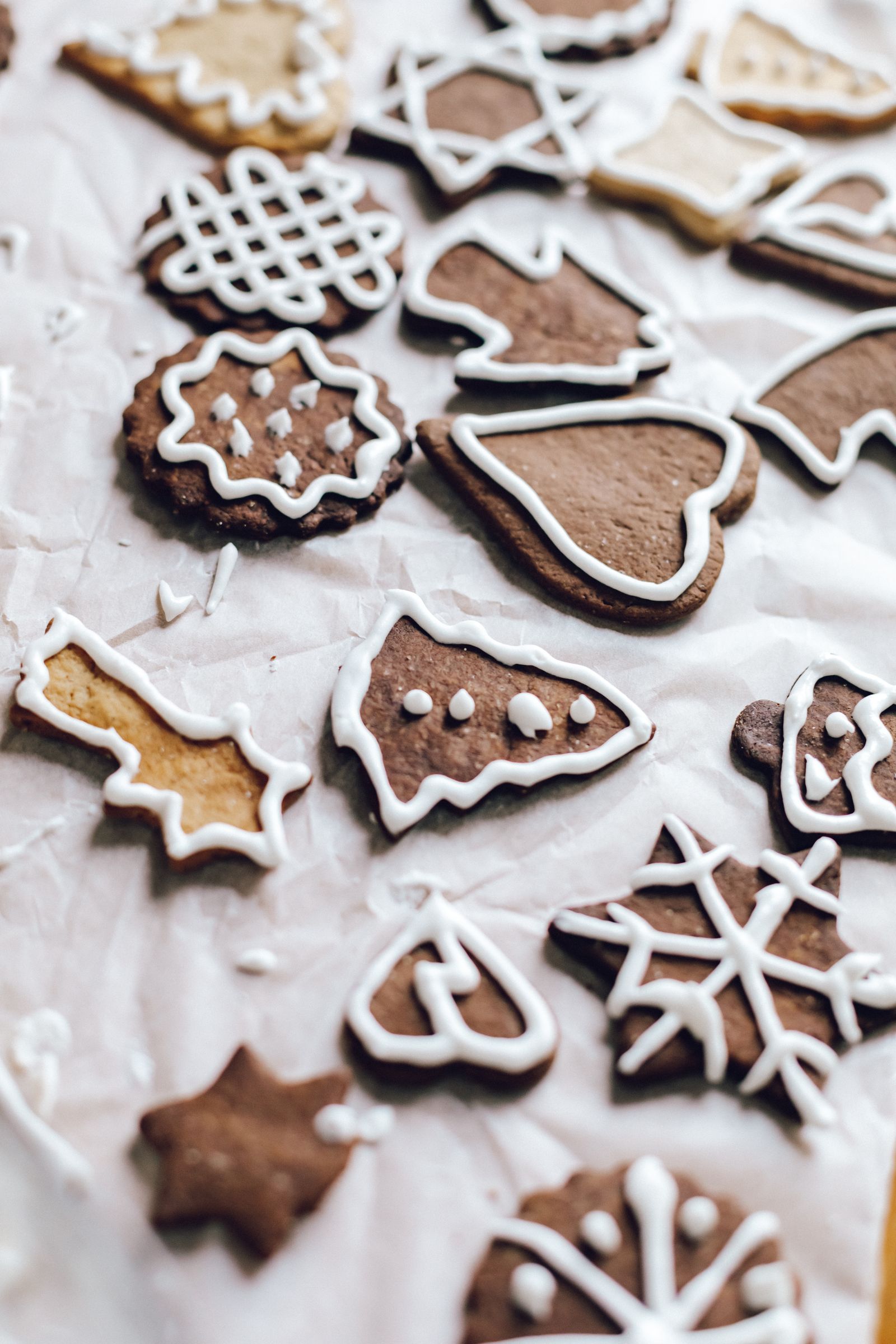 A selection of homemade iced gingerbread cookies on baking paper