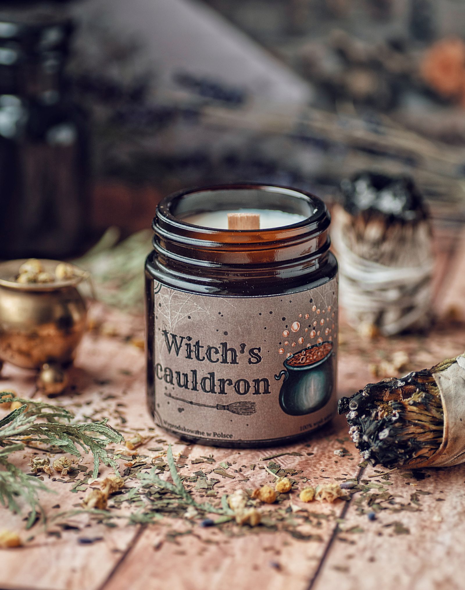 A witch's cauldron beside a lit candle